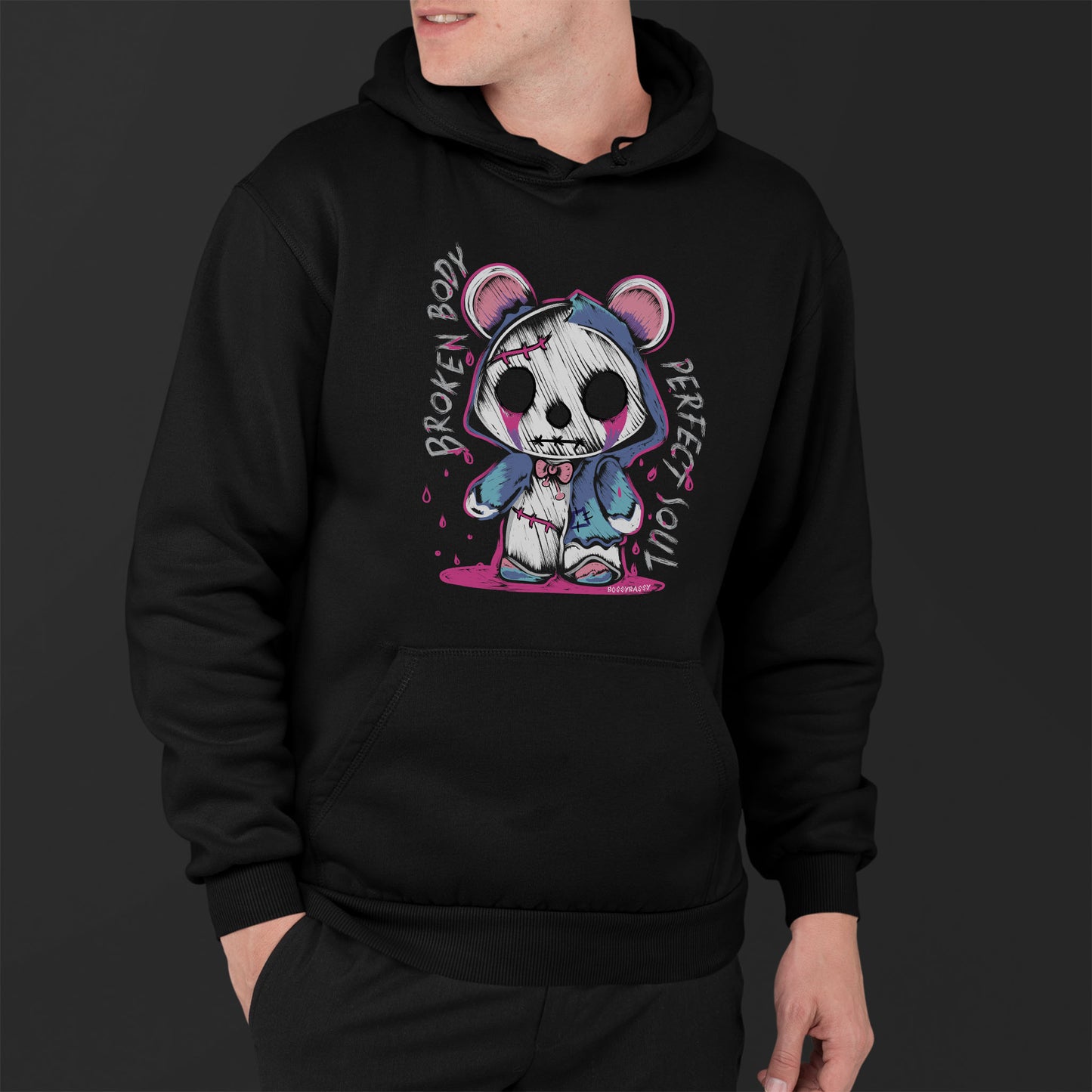Young Man Wearing A Unisex Black Hoodie With A Gothic Emo Hand Drawn Bear Design With Text Broken Soul Perfect Body