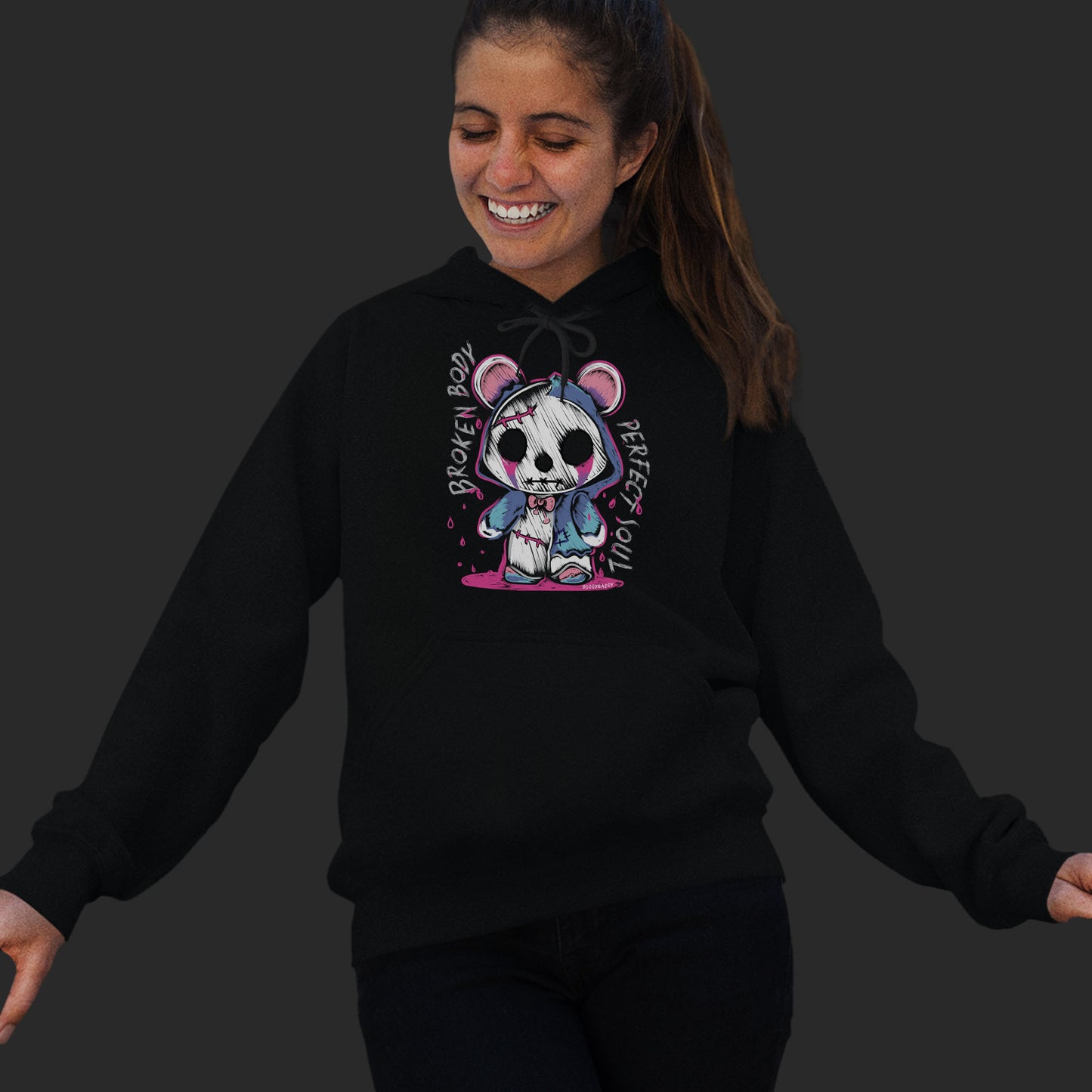 Young Woman Wearing A Unisex Black Hoodie With A Gothic Emo Hand Drawn Bear Design With Text Broken Soul Perfect Body