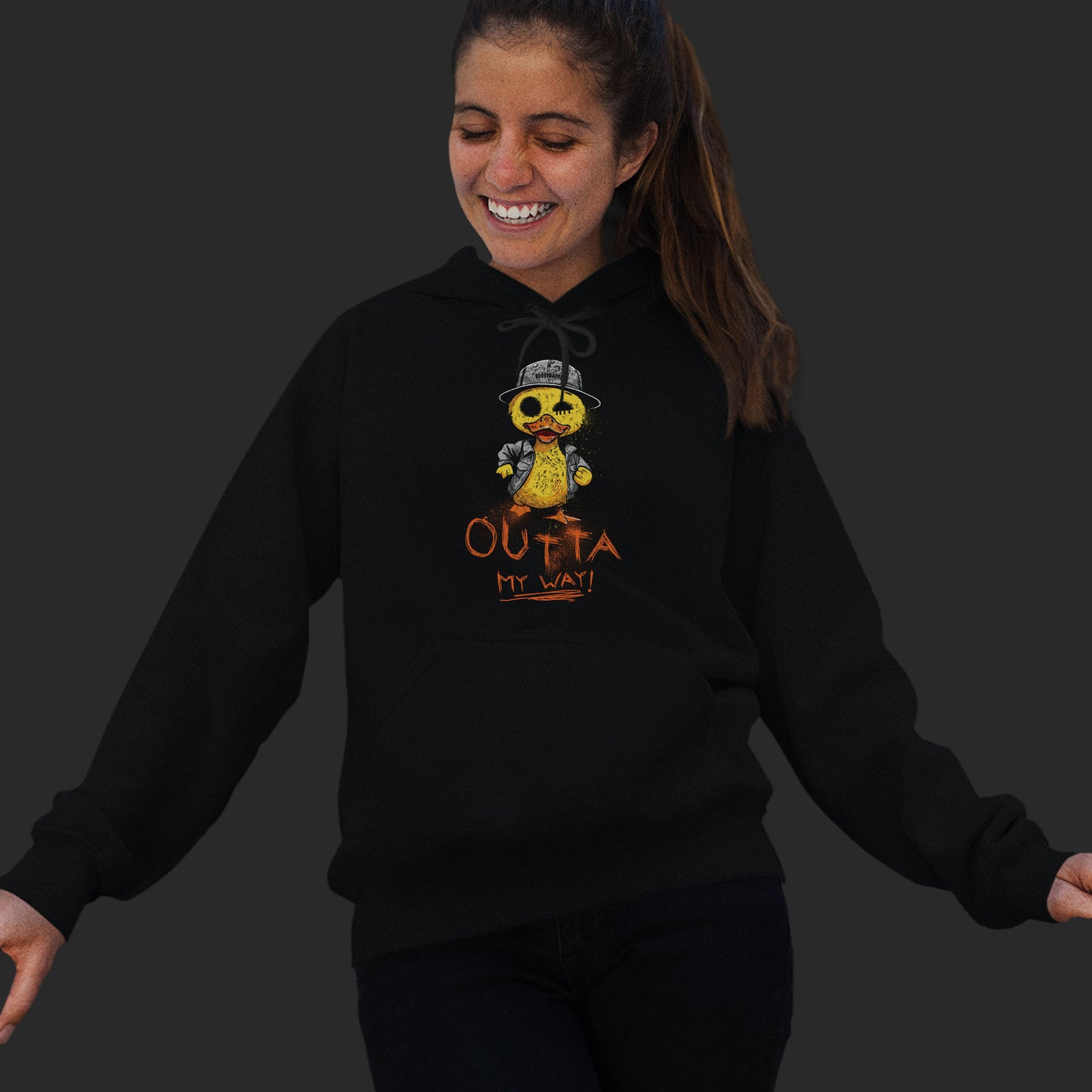 Woman Wearing A Black Hoodie With  A Hand-Drawn Illustration of A Rude Duck With The Phrase Outta My Way
