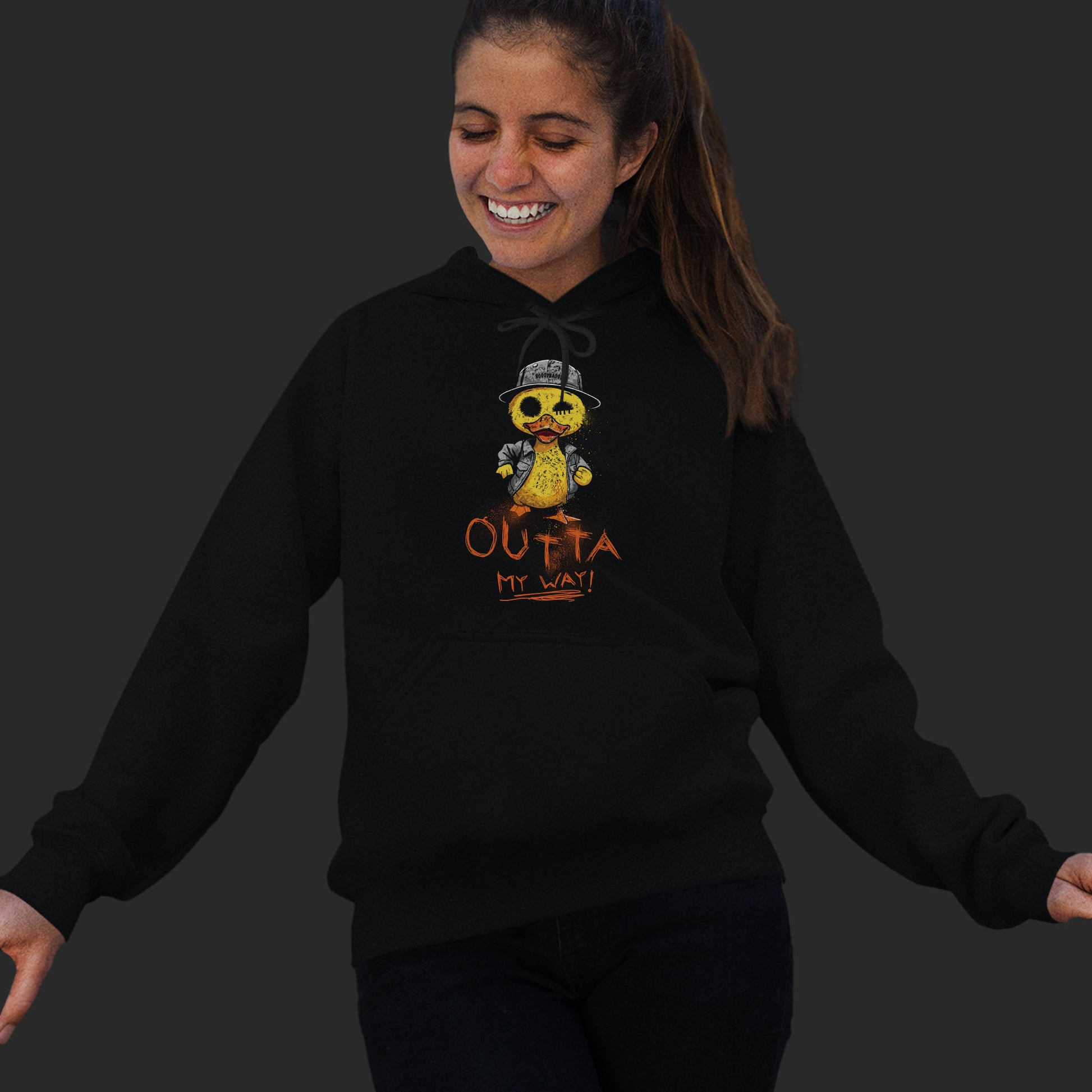 Woman Wearing A Black Hoodie With  A Hand-Drawn Illustration of A Rude Duck With The Phrase Outta My Way