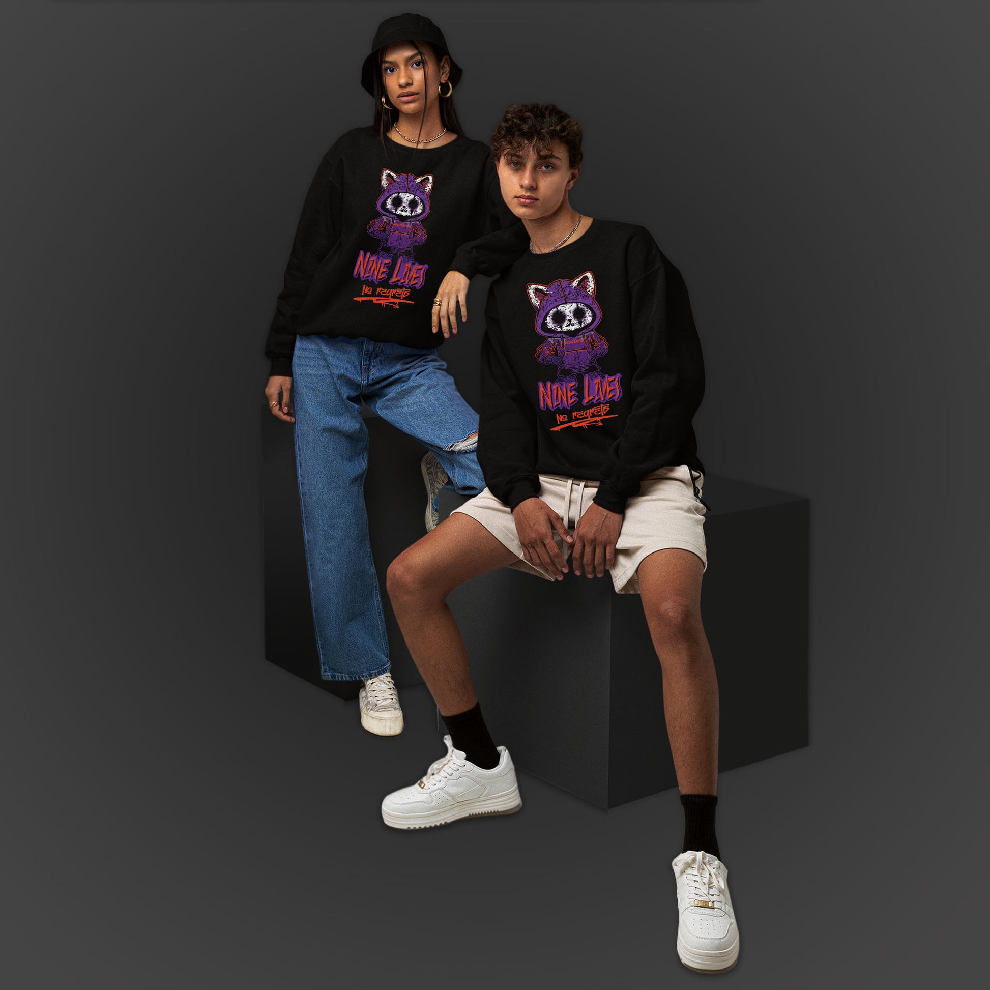 Young Couple Wearing A Black Sweatshirt With A Gothic Emo Cat Design And Text  Nine Lives No Regrets