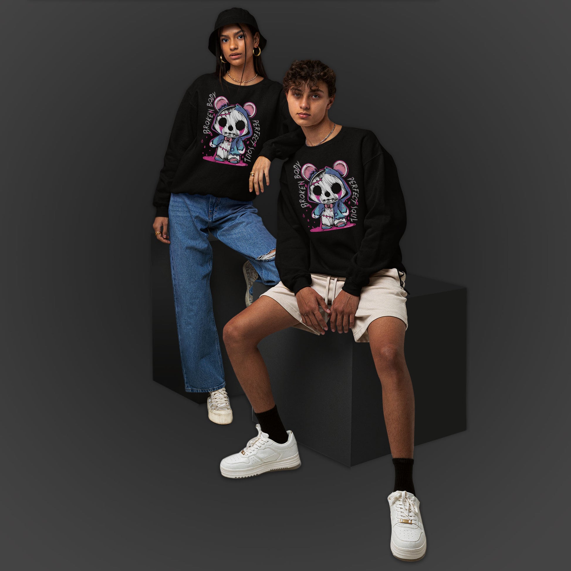 Young Couple Wearing A Black Sweatshirt With A Gothic Emo Hand Drawn Bear Design With Text Broken Soul Perfect Body