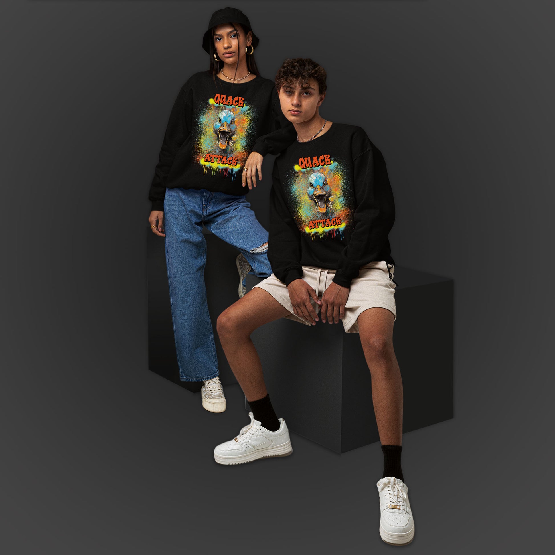 Young Couple Wearing A Black Sweatshirt With A Illustration Of A Colorfull Crazy Street Duck And Text Quack Attack-Graffiti Style Design