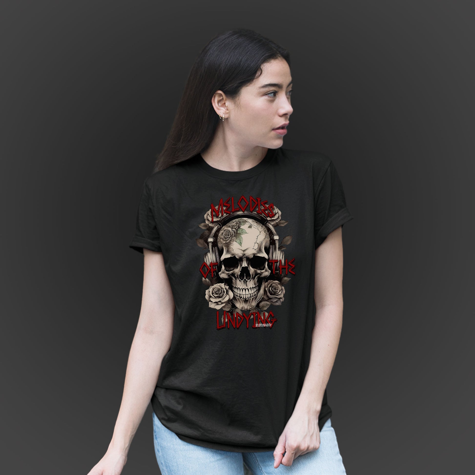 woman wearing a black unisex tshirt features an illustration of a vintage skull skeleton with roses and the text Melodies of the Undying