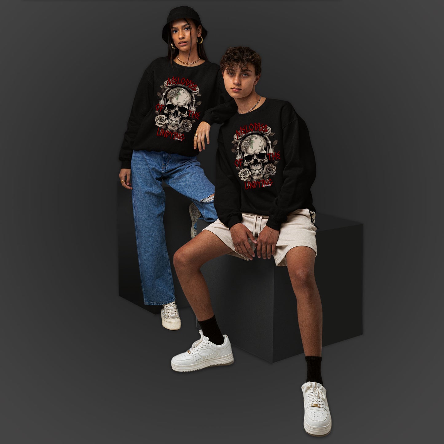 Young Couple Wearing A Black Sweatshirt With An Illustration Of A Vintage Skull Skeleton With Roses And Text Melodies Of The Undying