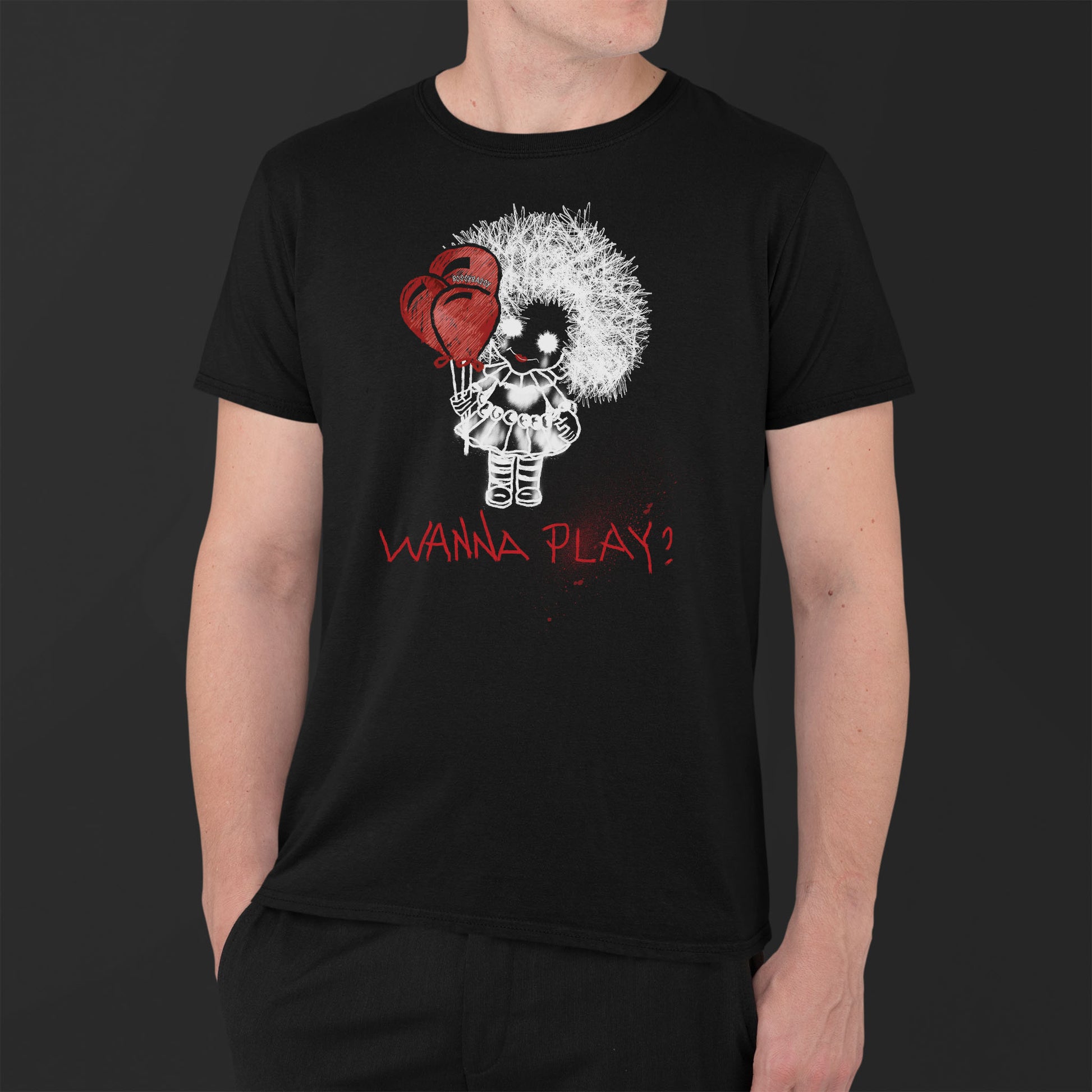 man wearing a black unisex tshirt features a hand-drawn illustration of a spooky girl with red balloons and the phrase wanna play