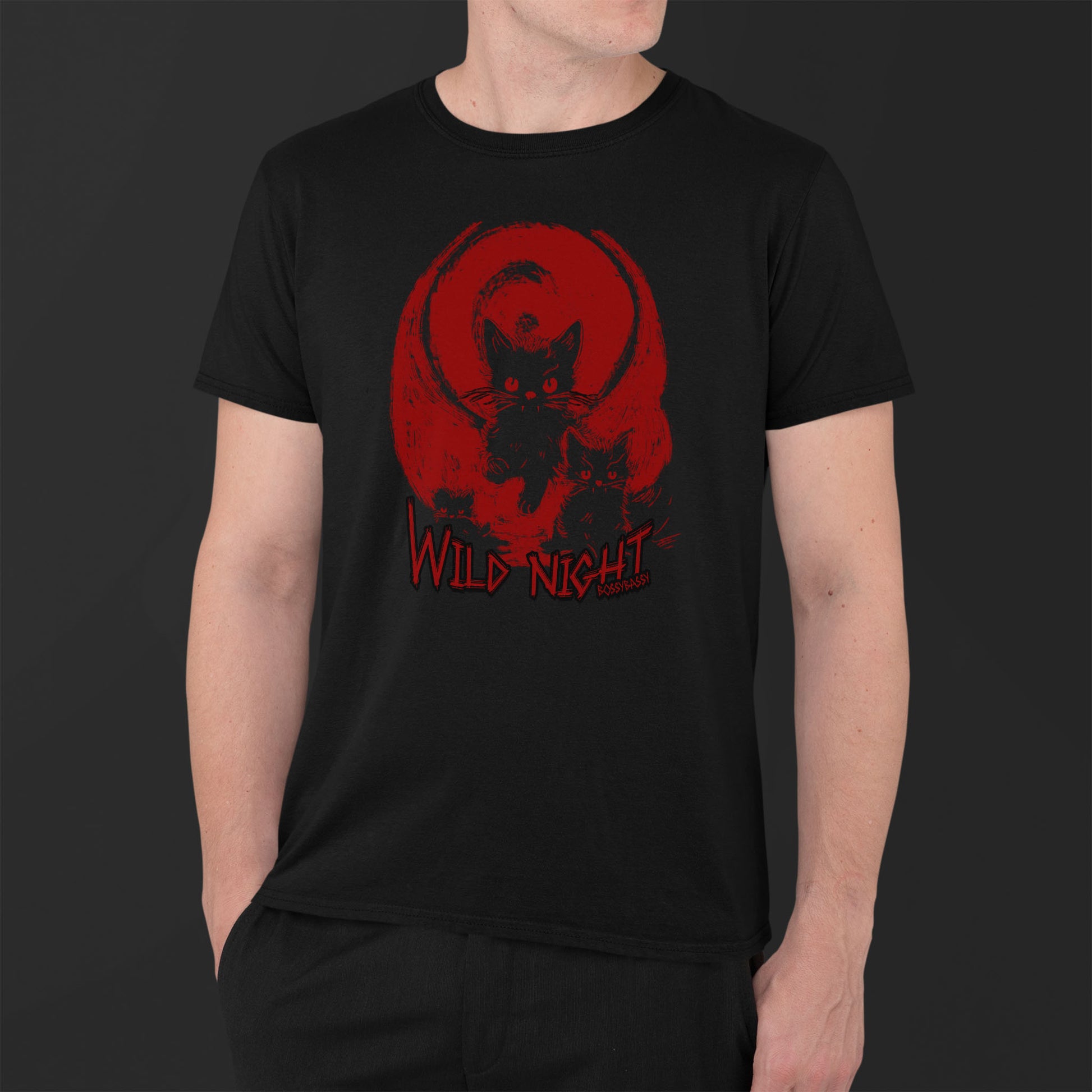 young man wearing a black unisex tshirt features an illustration of black cats with a red background and the text wild night