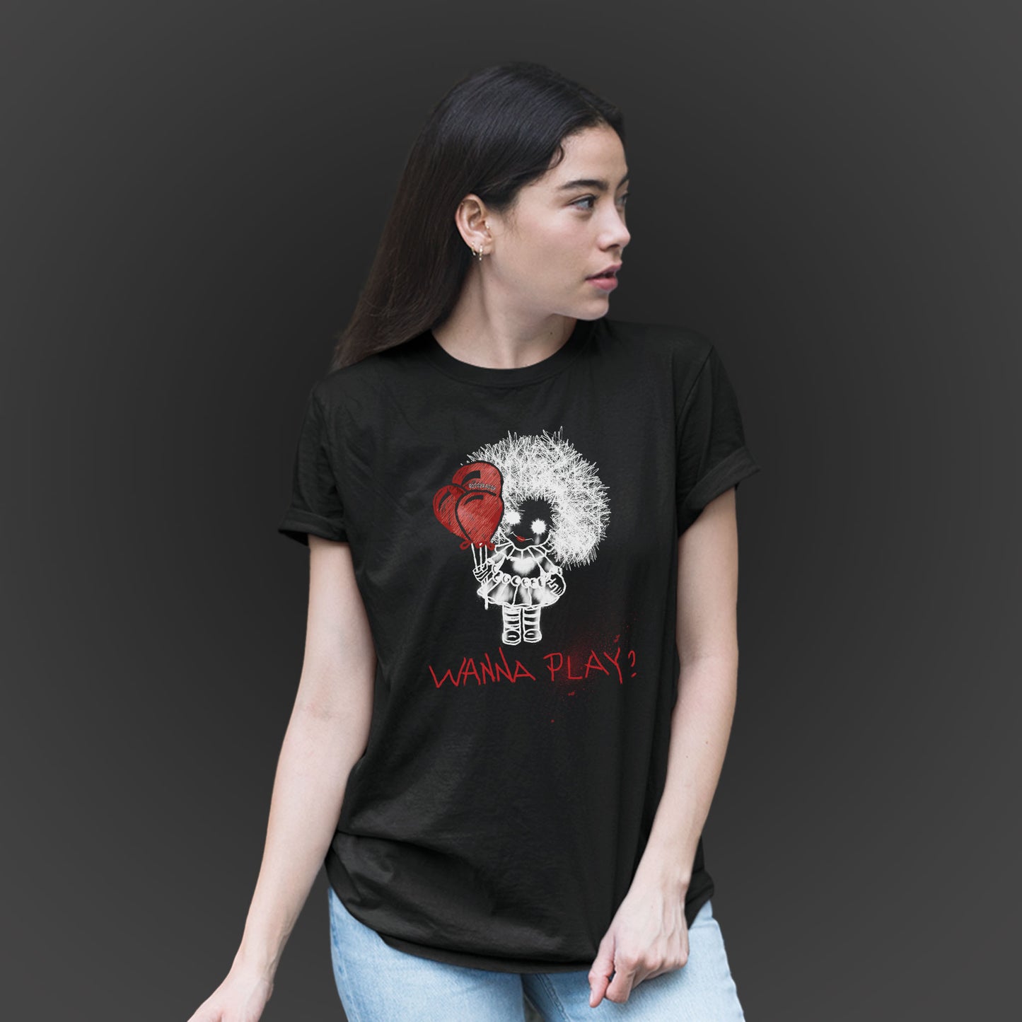 woman wearing a black unisex tshirt features a hand-drawn illustration of a spooky girl with red balloons and the phrase wanna play