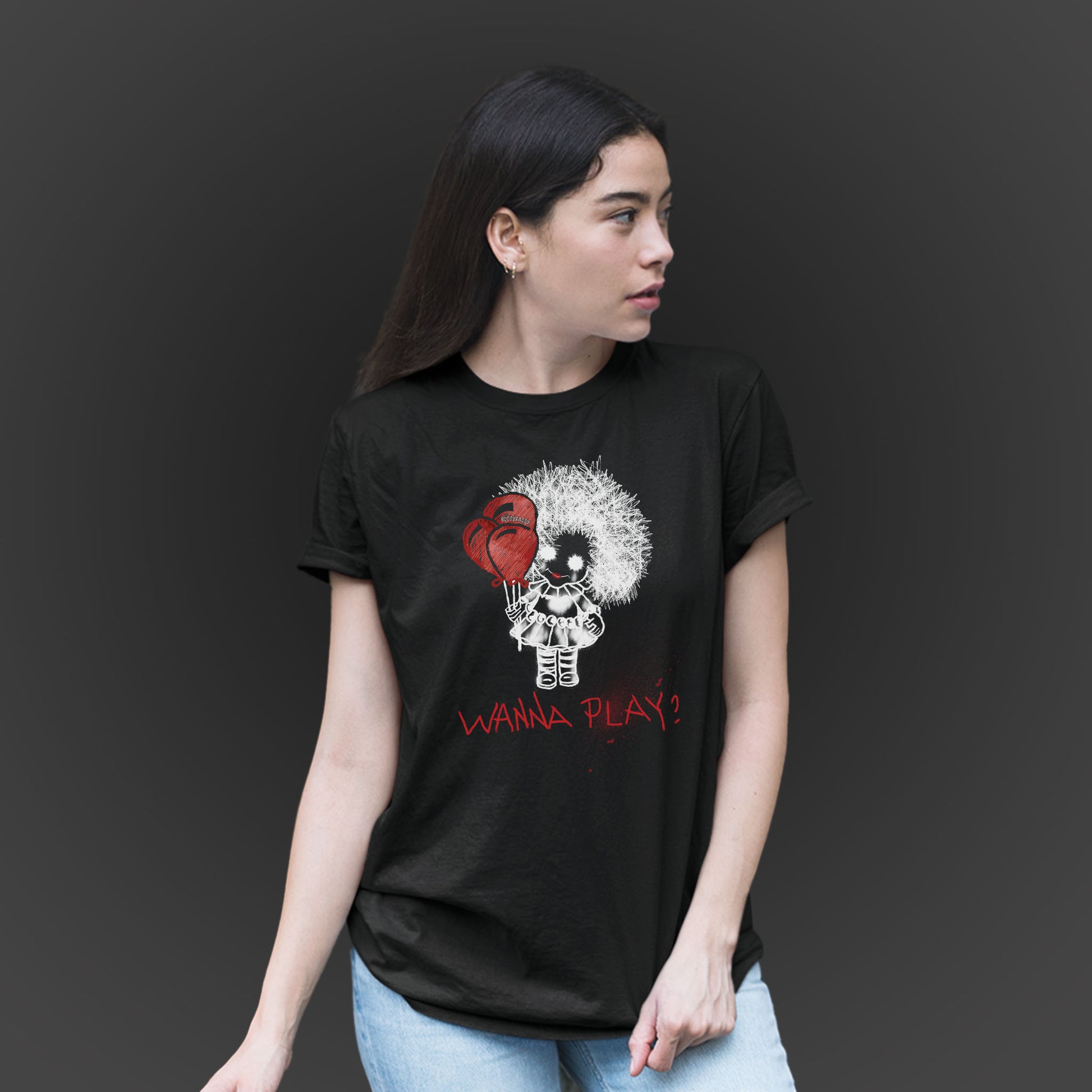 woman wearing a black unisex tshirt features a hand-drawn illustration of a spooky girl with red balloons and the phrase wanna play