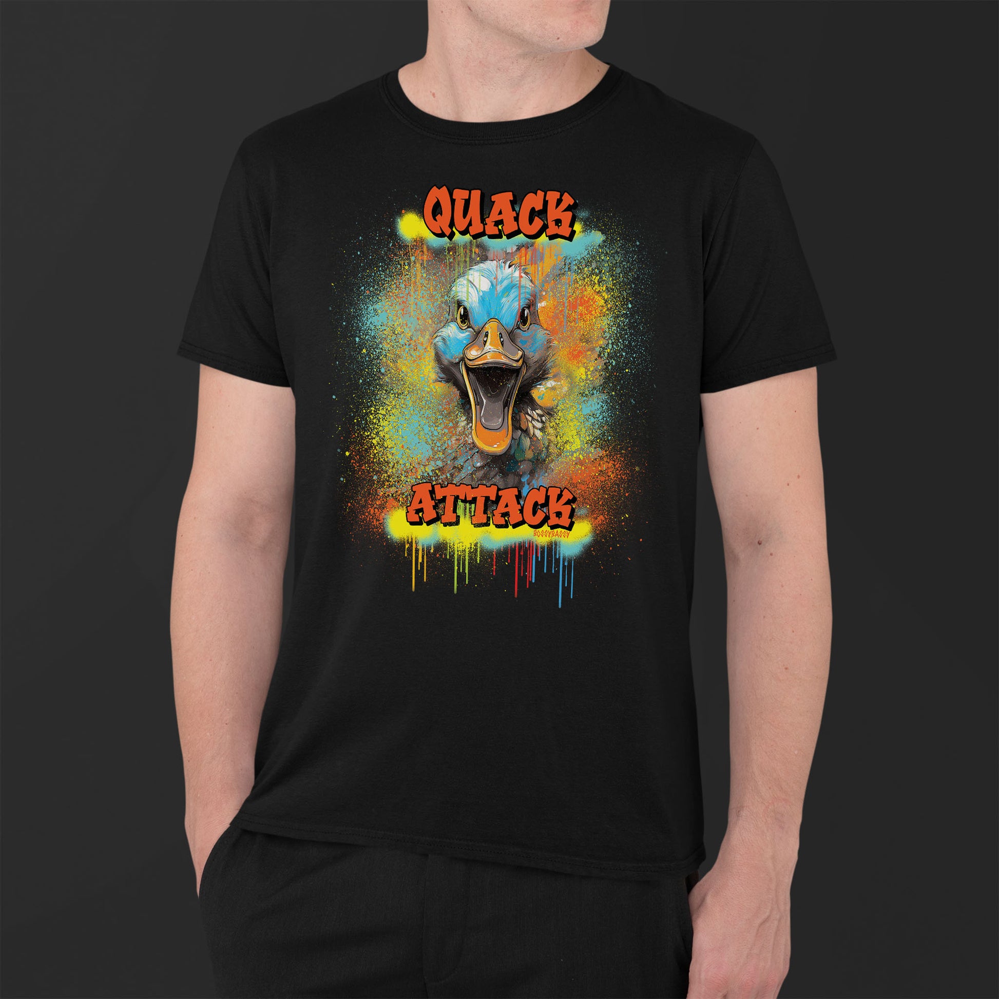 younger man wearing a black unisex tshirt with a crazy duck and text quack attack with graffiti design