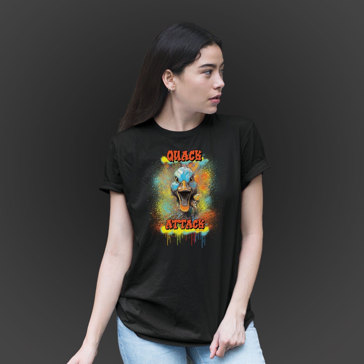 younger woman wearing a black unisex tshirt with a crazy duck and text quack attack with graffiti design